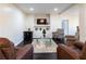 Cozy living room includes a TV, modern decor, hardwood floors, and comfortable seating around a glass coffee table at 7445 Talbot Colony, Atlanta, GA 30328