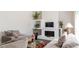 Bright and airy living room with comfortable gray sofas, a white fireplace, and stylish accents at 7445 Talbot Colony, Atlanta, GA 30328