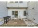 Patio area with rocking chairs in a backyard with sliding glass door and storage at 2015 Kilmington Sq, Alpharetta, GA 30009