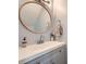 Bathroom with modern fixtures, oval mirror, and neutral gray cabinets at 2015 Kilmington Sq, Alpharetta, GA 30009