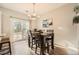Cozy dining area with hardwood floors, sliding glass door, and a modern chandelier at 2015 Kilmington Sq, Alpharetta, GA 30009