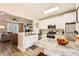 Bright kitchen featuring granite countertops, stainless steel appliances, and open layout to living area at 2015 Kilmington Sq, Alpharetta, GA 30009