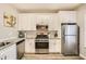 Kitchen with white cabinets, granite counters, and stainless steel appliances at 2015 Kilmington Sq, Alpharetta, GA 30009