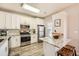 Modern kitchen with white cabinets, stainless steel appliances, granite countertops, and hardwood floors at 2015 Kilmington Sq, Alpharetta, GA 30009