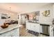 Open kitchen with white cabinets, granite counters, stainless appliances, and dining area at 2015 Kilmington Sq, Alpharetta, GA 30009