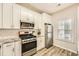 Kitchen with stainless steel appliances, white cabinets, and granite countertops at 2015 Kilmington Sq, Alpharetta, GA 30009