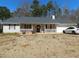 Charming single-story home featuring a well-maintained front yard, white picket fence and attached garage at 230 Laurel Way, Covington, GA 30016