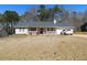 Charming single-story home featuring a well-maintained front yard, white picket fence and attached garage at 230 Laurel Way, Covington, GA 30016