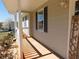 Covered front porch showcasing a seating area and shade, perfect for relaxing and enjoying the outdoors at 230 Laurel Way, Covington, GA 30016