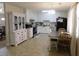 Bright kitchen featuring white cabinetry, modern appliances, and a dining area, creating a functional and stylish space at 230 Laurel Way, Covington, GA 30016