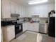 Well-equipped kitchen with stainless steel appliances, granite countertops, and ample cabinet space, providing a modern design at 230 Laurel Way, Covington, GA 30016