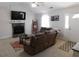 Cozy living room with a stone fireplace, comfortable seating, and large windows, creating a relaxing atmosphere at 230 Laurel Way, Covington, GA 30016