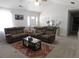 Spacious living room featuring a comfortable sectional sofa, rug, and a ceiling fan, providing a relaxing atmosphere at 230 Laurel Way, Covington, GA 30016