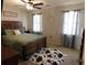Spacious main bedroom features a wood frame bed, ceiling fan, and natural light at 230 Laurel Way, Covington, GA 30016
