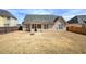 Spacious backyard featuring covered patio, fire pit, and fencing, ideal for outdoor enjoyment at 27 Spring Folly Nw, Cartersville, GA 30121