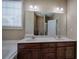 Bathroom featuring a double vanity, large mirror and soaking tub by the window at 27 Spring Folly Nw, Cartersville, GA 30121