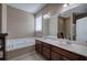 Bathroom featuring a double vanity, large mirror and soaking tub at 27 Spring Folly Nw, Cartersville, GA 30121