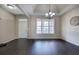 Open dining space with hardwood flooring and chandelier that creates a warm ambiance at 27 Spring Folly Nw, Cartersville, GA 30121