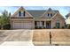 Charming brick home featuring a well-manicured lawn, two-car garage, and inviting covered porch, ideal for suburban living at 27 Spring Folly Nw, Cartersville, GA 30121