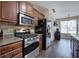 Kitchen features stainless steel appliances, brick backsplash, and dark wood cabinets at 27 Spring Folly Nw, Cartersville, GA 30121