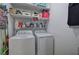 Functional laundry room features a washer, dryer and convenient shelving for storage at 27 Spring Folly Nw, Cartersville, GA 30121