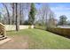 Large backyard featuring new wooden privacy fence and mature trees at 4985 Crowe Se Dr, Smyrna, GA 30082
