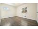 Spacious bedroom with hardwood floors and natural light from two windows at 4985 Crowe Se Dr, Smyrna, GA 30082
