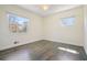 Sunlit bedroom with hardwood floors, ceiling fan, and two large windows at 4985 Crowe Se Dr, Smyrna, GA 30082
