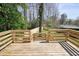 View of the wooden deck showcasing backyard with fence, trees, and sky at 4985 Crowe Se Dr, Smyrna, GA 30082