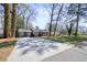 Wide driveway leading to a charming single-story home with gray exterior and carport at 4985 Crowe Se Dr, Smyrna, GA 30082