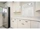 Modern kitchen featuring stainless steel refrigerator, white cabinetry, and granite countertops at 4985 Crowe Se Dr, Smyrna, GA 30082