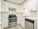 Updated kitchen features stainless steel appliances, white cabinetry, and granite countertops at 4985 Crowe Se Dr, Smyrna, GA 30082