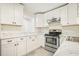Well-lit kitchen showcasing white cabinets, countertops, and stainless steel oven at 4985 Crowe Se Dr, Smyrna, GA 30082