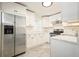 Modern kitchen with stainless steel refrigerator, white cabinetry, and granite countertops at 4985 Crowe Se Dr, Smyrna, GA 30082