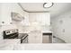 Bright kitchen features white cabinets, stainless steel appliances, and marble countertops at 4985 Crowe Se Dr, Smyrna, GA 30082