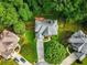 Aerial view of a backyard with a well-maintained roof, deck, and lush landscaping at 5425 Edinbourgh Ct, Cumming, GA 30040