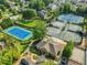 An aerial shot highlights tennis courts and the community clubhouse surrounded by landscaped grounds at 5425 Edinbourgh Ct, Cumming, GA 30040