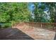 Angle view of backyard deck with wooden railing and surrounding trees at 5425 Edinbourgh Ct, Cumming, GA 30040