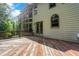 View of backyard with deck, multiple windows, and lush green trees at 5425 Edinbourgh Ct, Cumming, GA 30040