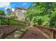 Backyard with wooden fencing, steps to the deck, and lush landscaping at 5425 Edinbourgh Ct, Cumming, GA 30040