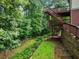 The tiered backyard features a multi-level deck and lush green landscaping at 5425 Edinbourgh Ct, Cumming, GA 30040