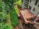 Spacious multi-level wooden deck surrounded by lush landscaping and mature trees at 5425 Edinbourgh Ct, Cumming, GA 30040