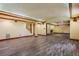 Large finished basement featuring wood style floors, pillars, and recessed lighting at 5425 Edinbourgh Ct, Cumming, GA 30040