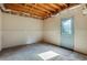 Unfinished basement space with carpet, exposed ceiling, and walkout access at 5425 Edinbourgh Ct, Cumming, GA 30040