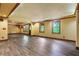 Finished basement with wood-look floors, recessed lighting, and large windows at 5425 Edinbourgh Ct, Cumming, GA 30040