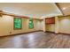 Finished basement with hardwood style floors, built-in cabinets, and recessed lighting at 5425 Edinbourgh Ct, Cumming, GA 30040