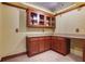 Basement features wet bar with custom cabinetry and tile flooring at 5425 Edinbourgh Ct, Cumming, GA 30040