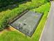 Aerial view showcases a fenced outdoor basketball court with surrounding greenery at 5425 Edinbourgh Ct, Cumming, GA 30040