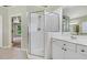 This bright bathroom features a glass enclosed shower, updated fixtures, and plenty of counter space at 5425 Edinbourgh Ct, Cumming, GA 30040