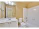 This full bathroom features a shower-tub combo, neutral colored walls, and a white vanity sink at 5425 Edinbourgh Ct, Cumming, GA 30040